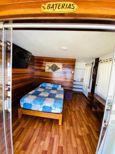 a bedroom with a bed and a wooden wall at Casa Lobos in Lobitos