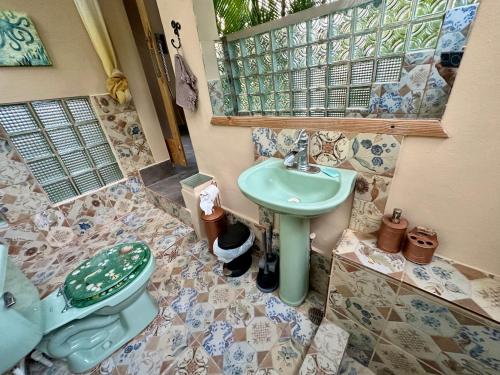 a bathroom with a sink and a toilet at Cabarete Boutique Kite Hotel King Loft in Cabarete