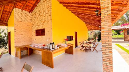 an outdoor patio with a table and chairs at Pousada Sítio Machado in Viçosa do Ceará