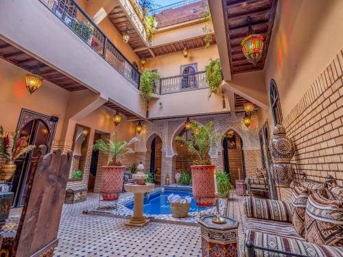 an indoor courtyard with a pool in a house at Riad Irhalne in Marrakesh