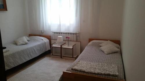 a small bedroom with two beds and a window at Apartments by the sea Bakarac, Kraljevica - 21710 in Bakarac