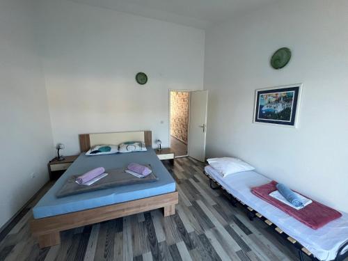 a bedroom with two beds in a room at Apartments by the sea Jelsa, Hvar - 22256 in Jelsa