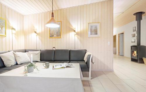 a living room with a couch and a table at 4 Bedroom Stunning Home In Glesborg in Glesborg