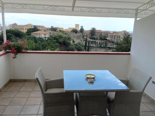 a table and chairs in a balcony with a view at Villa il Barone in Tropea