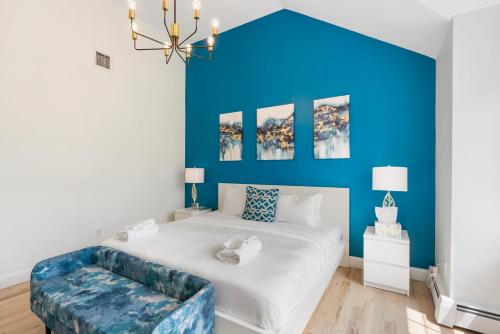 a bedroom with a large bed with a blue wall at Malkita Aria Mountainview Retreat in Woodbury