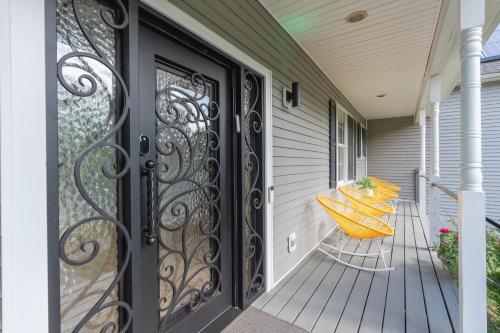 a porch with two yellow benches on a house at Malkita Aria Mountainview Retreat in Woodbury