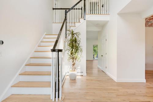 a staircase in a house with a potted plant at Malkita Aria Mountainview Retreat in Woodbury