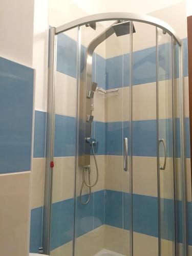 a shower with blue and white stripes in a bathroom at Villa il Barone - Free Private Parking in Tropea