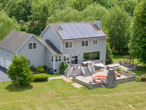 an aerial view of a house with solar panels on the roof at Malkita Aria Mountainview Retreat in Woodbury