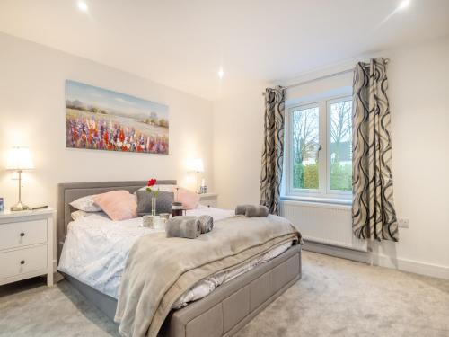 a bedroom with a bed and a window at Walcot House Stables in Diss