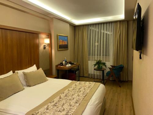 a hotel room with a bed and a desk at İstport Hotels in Arnavutköy