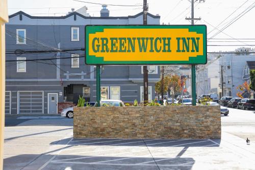 a yellow sign for a greenwich inn on a street at Greenwich Inn in San Francisco