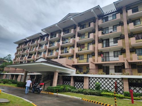 a person standing in front of a large building at NORTHPOINT CONDO Free Airport Pick Up for 3 nights stay or more in Davao City