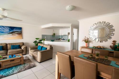 a living room with a table and a dining room at Key Largo Holiday Apartments in Gold Coast