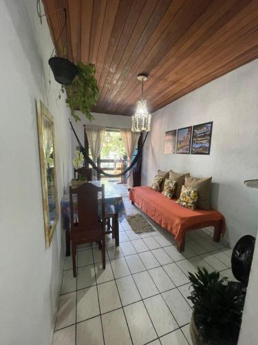 a bedroom with a bed and a table in a room at Nova Conquista in Paraty