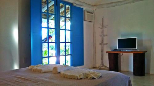 Tempat tidur dalam kamar di Pousada Casa da Praia Itaúnas