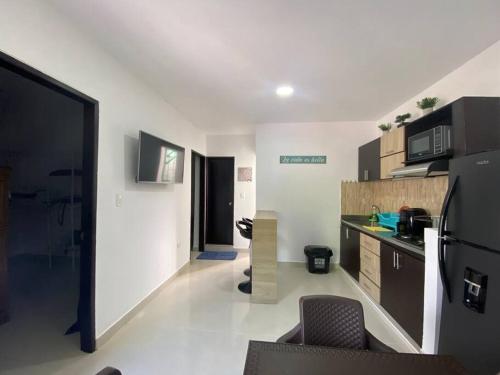 a kitchen with a refrigerator and a counter top at Apartamento central in Apartadó