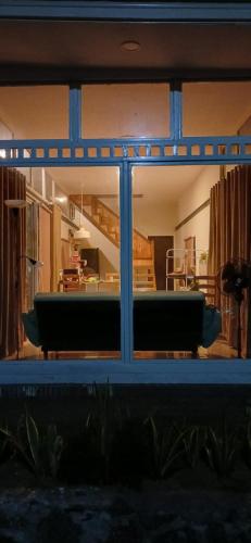 a view of a living room through a window at Double Decker Container Cabin at Umah Chronosphere Bali in Balian