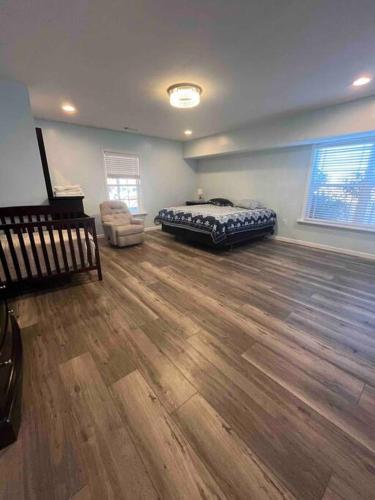 a bedroom with a bed and a chair in a room at Large 5 Bedroom Home Near Downtown Dalton in Dalton