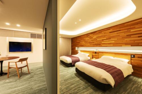 Ένα ή περισσότερα κρεβάτια σε δωμάτιο στο Hotel Yutoria Fujisato