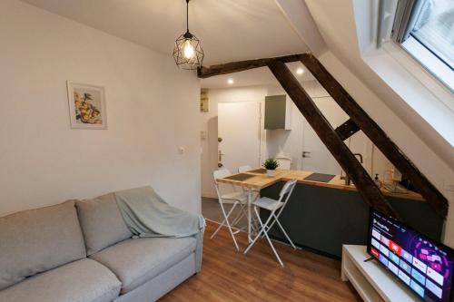 a living room with a couch and a desk at Lafra - Charming & Intimate - Mon Groom in Troyes