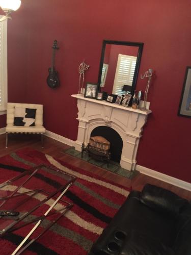 a living room with a fireplace and a mirror at Huffman House Bed & Breakfast in Minden