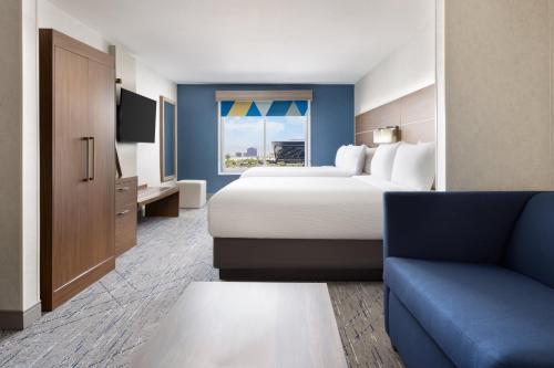 a hotel room with a bed and a couch at Holiday Inn Express Las Vegas Stadium Area by IHG in Las Vegas