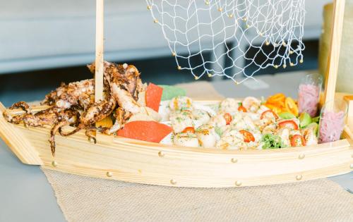 a basket of food with shrimp and vegetables in it at Kimpton Surfcomber Hotel by IHG in Miami Beach