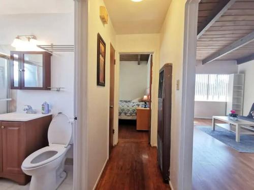 a bathroom with a toilet and a sink in a room at Cozy 2Br 1Bath Home w/ Parking near El Cerrito and University of Berkeley in Richmond
