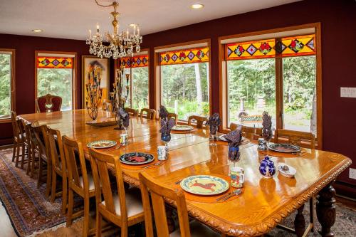 a dining room with a large wooden table and chairs at Hidden Valley Bed and Breakfast in Whitehorse