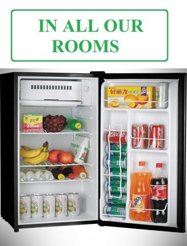 an open refrigerator filled with food and drinks at Men House JFK Airport in Brooklyn Manor