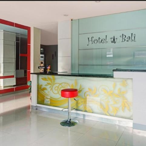 a red stool in the middle of a lobby at HOTEL BALI MAKASSAR in Makassar