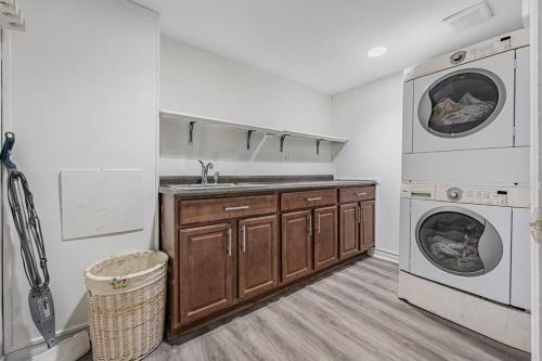 a kitchen with a sink and a washing machine at Cozy Haven Retreat 2Bed Basement in Whitby