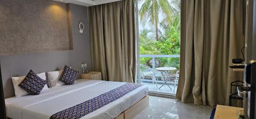 a hotel room with a bed and a large window at Arora View in Maafushi