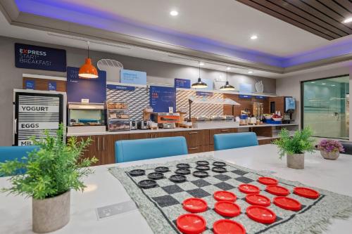 a dining room with a table and a chessboard at Holiday Inn Express Hershey-Harrisburg Area by IHG in Hershey