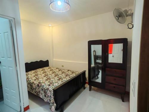 a bedroom with a bed and a dresser and a mirror at Casa Naranja in Granada