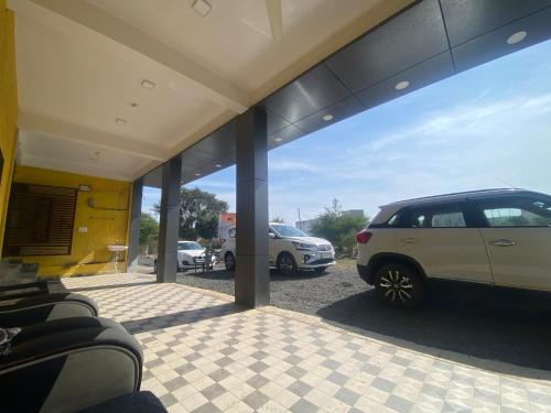 a garage with two cars parked in a parking lot at PATEL HOTEL in Shamsgarh