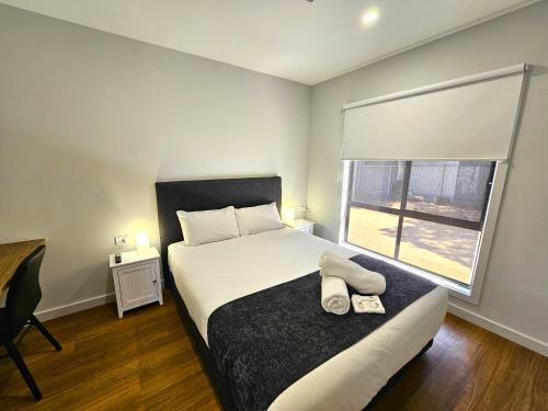 a bedroom with a large bed and a window at Murray Bridge Tourist Park in Murray Bridge