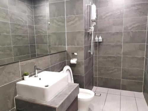 a bathroom with a sink and a toilet at Bell Suite @ Sepang By MHS in Sepang