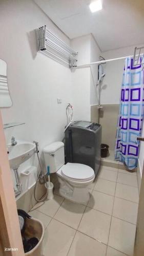a small bathroom with a toilet and a sink at Happy Stays C - 300mbps - 65"TV NetFlix, Disney - Loft in Trece Martires