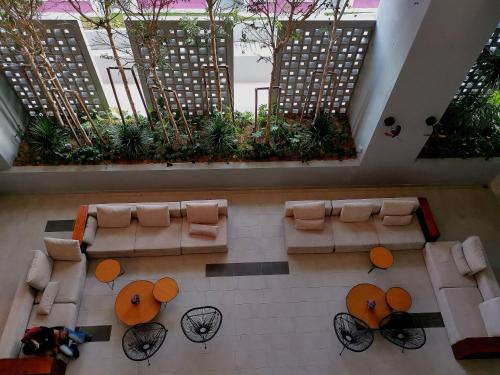 an overhead view of a lobby with couches and plants at Bell Suite @ Sepang By MHS in Sepang