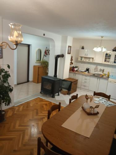 a living room with a wooden table and a stove at APARTMAN PAVELIĆ in Lovinac