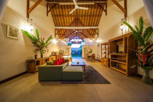 a large living room with a couch and a table at Luxury 3BR Infinity Jungle View Aashaya Villa Ubud in Ubud