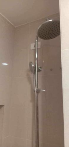 een douche met een glazen deur in de badkamer bij Condotel810 in Iloilo City
