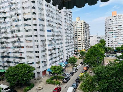 a city street with cars parked in front of tall buildings at Dailyroom C3,C4by Anna in Nonthaburi