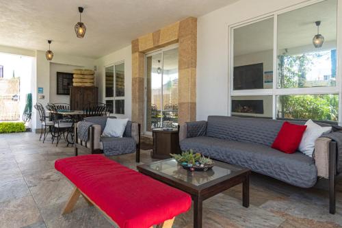 a living room with a couch and a table at Lujosa casa: alberca terapéutica 3x2m, chimenea, cocina profesional in León
