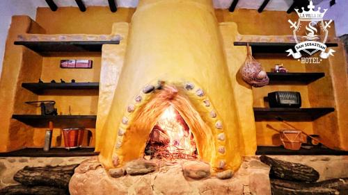 a restaurant with a pizza oven in a room at La Villa de San Sebastian Hotel in Villa de Leyva