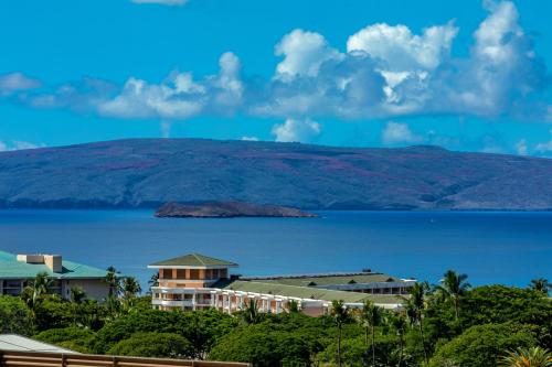 a view of a resort and the ocean and a mountain at Stunning ocean view! 2-2 in the heart of Wailea in Wailea