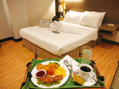 a tray of food on a table in a hotel room at Magallanes Square Hotel Inc. in Tagaytay