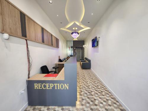 an office lobby with a reception desk and a reception counter at Hotel Near Me in Rajkot